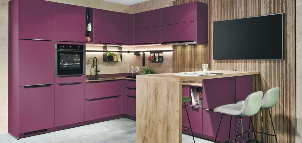 Beerenfarbene Küche mit Theke, Holzwand und Wandfernseher